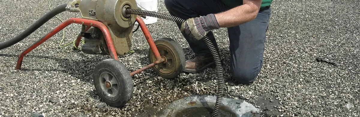 sewer rodding technician actively removing blockages from a sewer line in Orange, CA